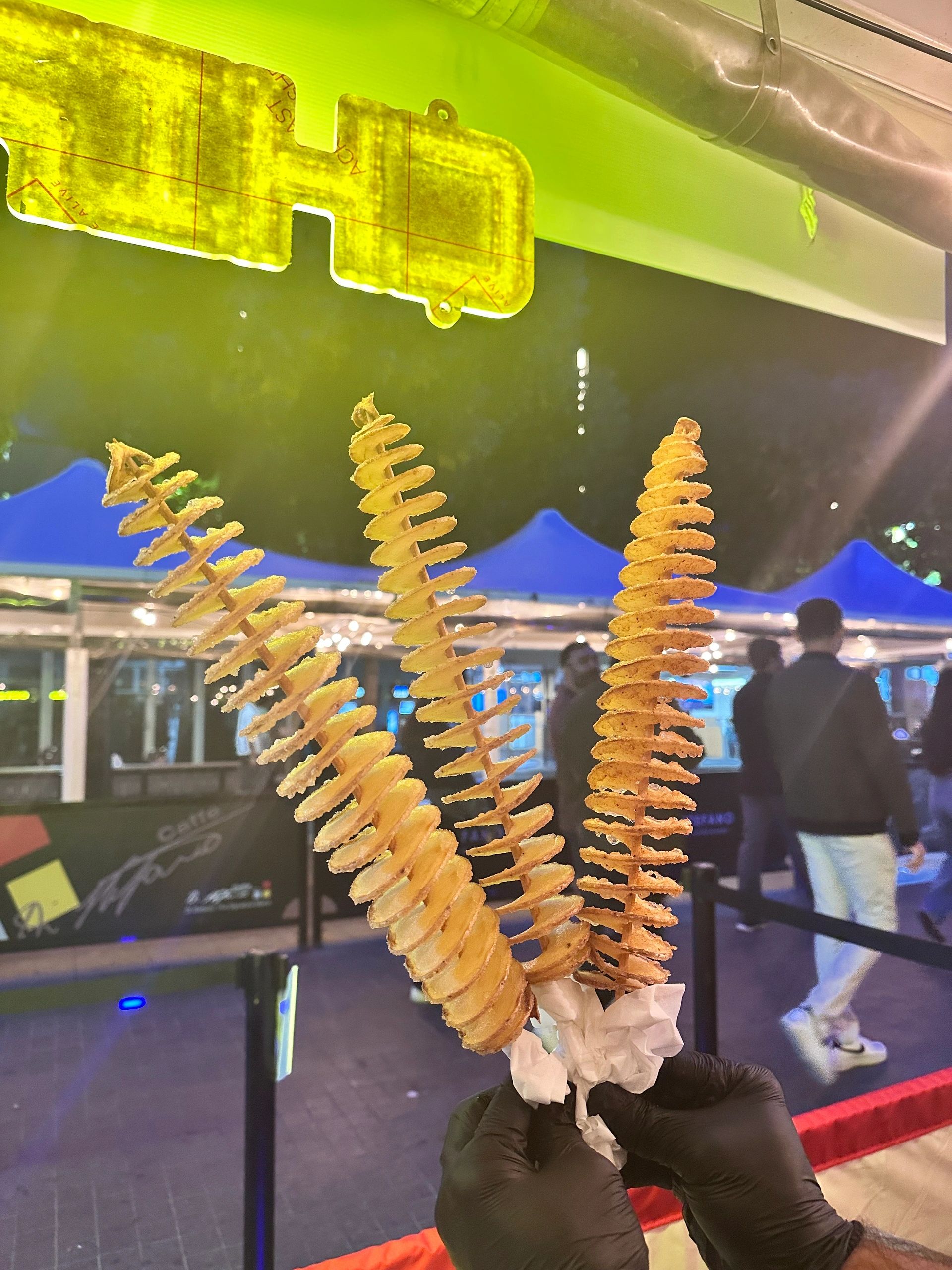 Spiral tornado potato chip golden fried on a stick at a carnival