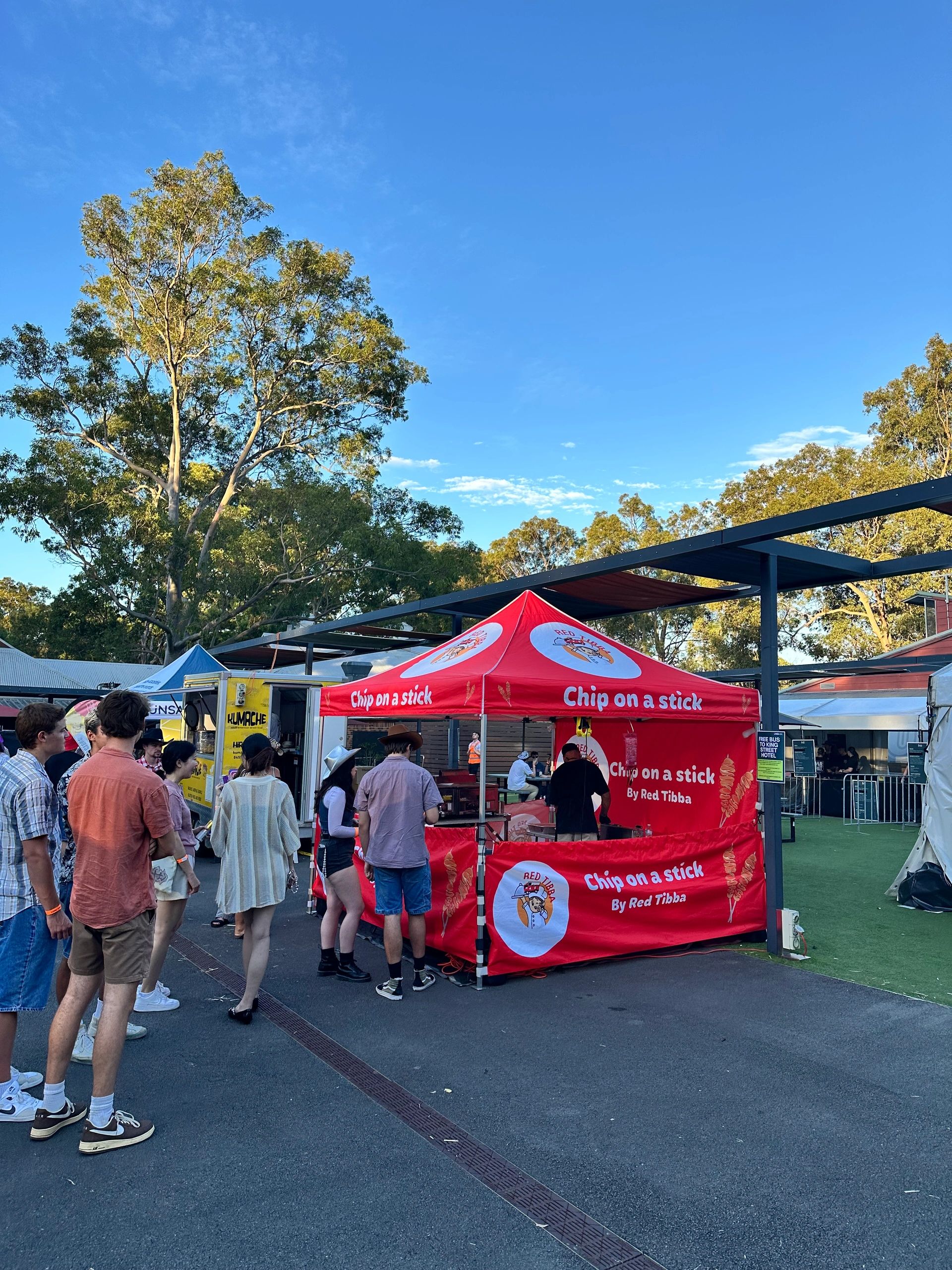 Red food vendor tent at a community fair